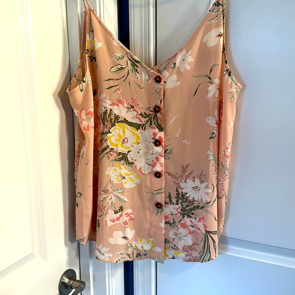 Loft outlet top with a background of pink and multicolored flowers